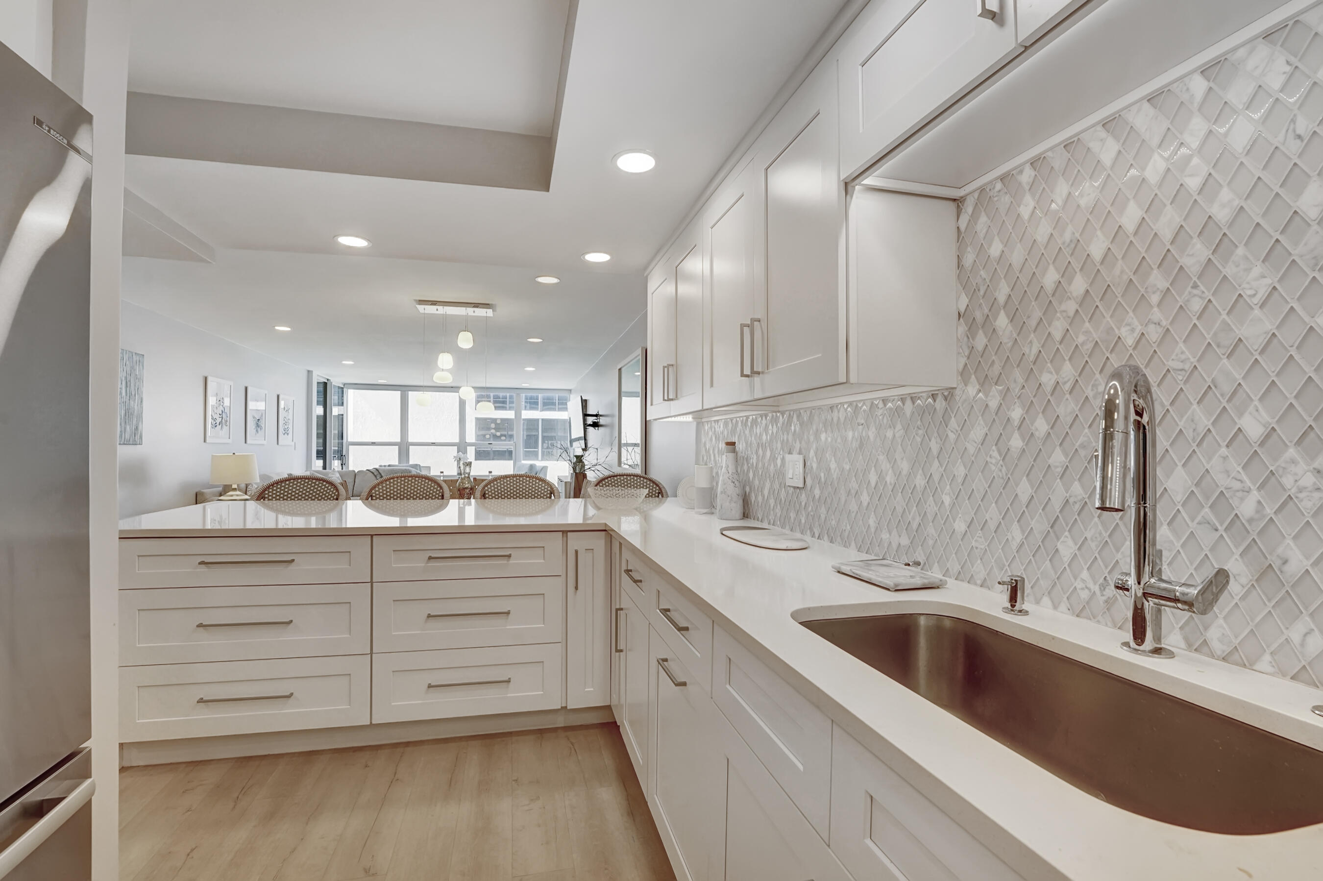 2175 South Ocean Boulevard, Unit 304 Delray Beach, FL 33483 - Photo 5 of 28 a kitchen with a sink cabinets and window