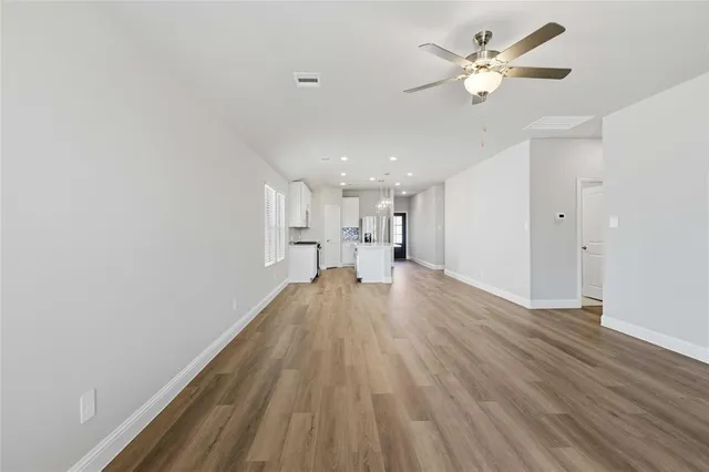 a view of a livingroom with a hardwood floor and a ceiling fan