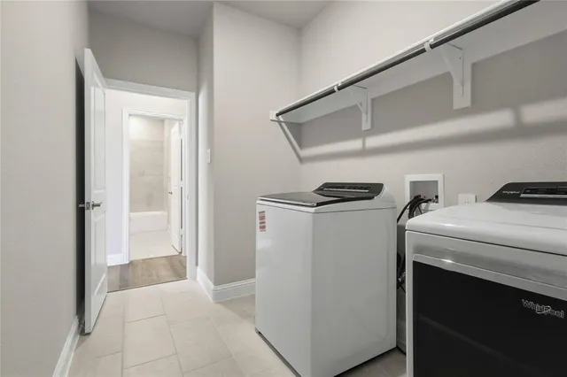 a view of storage and utility room with washer and dryer