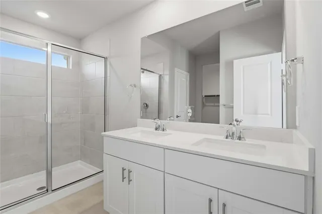 a bathroom with a shower sink and mirror