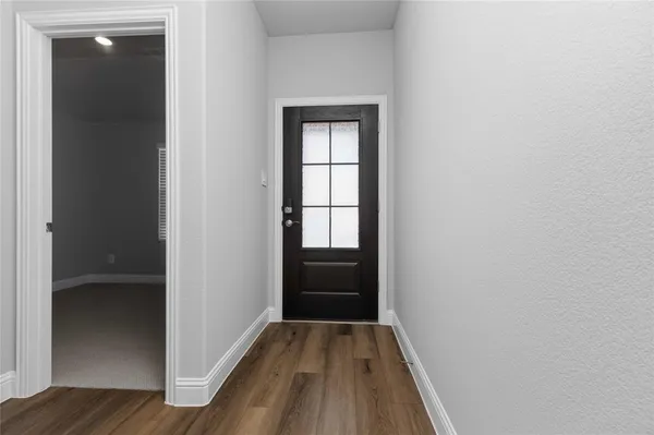 a view of hallway with wooden floor