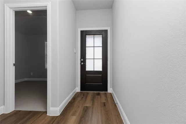 a view of hallway with wooden floor