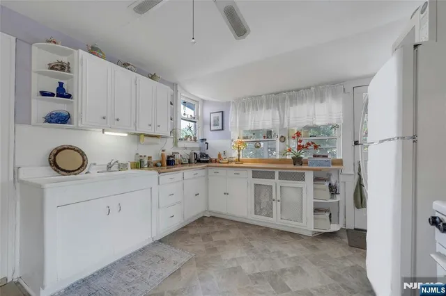 a kitchen with granite countertop cabinets and white appliances