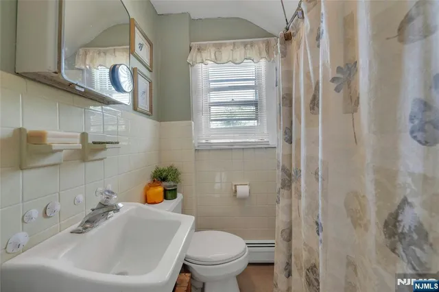 a white toilet sitting next to a bathroom sink