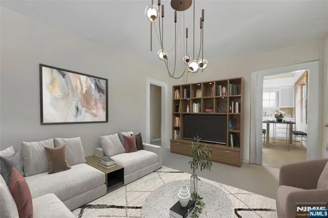 a living room with furniture a dining table and a chandelier
