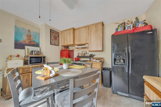 a view of a dining room with furniture a kitchen and chandelier
