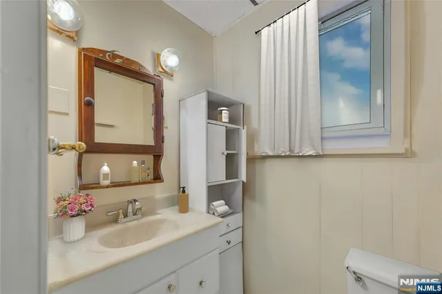 a bathroom with a sink vanity and mirror