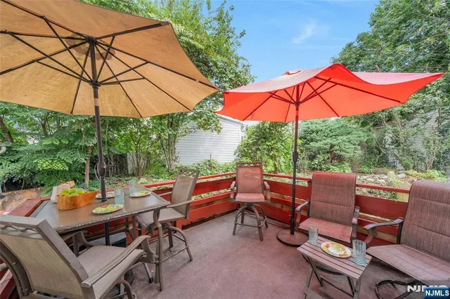 a view of an outdoor sitting area with furniture and umbrella