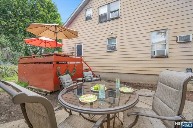 a balcony with table and chairs