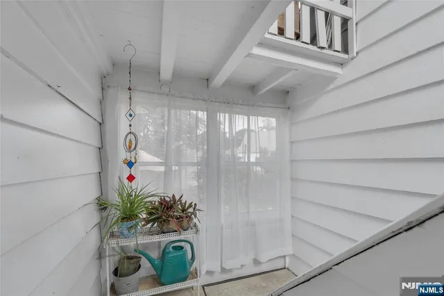 a vase of flowers sitting on a floor in front of a door