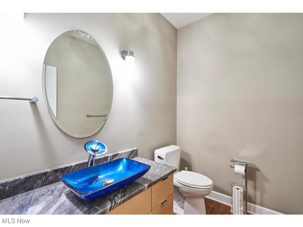 1570 Shade Road Akron, OH 44333 - Photo 14 of 45 The guest bath has hickory floors, custom amish built cabinet w quartz countertop.