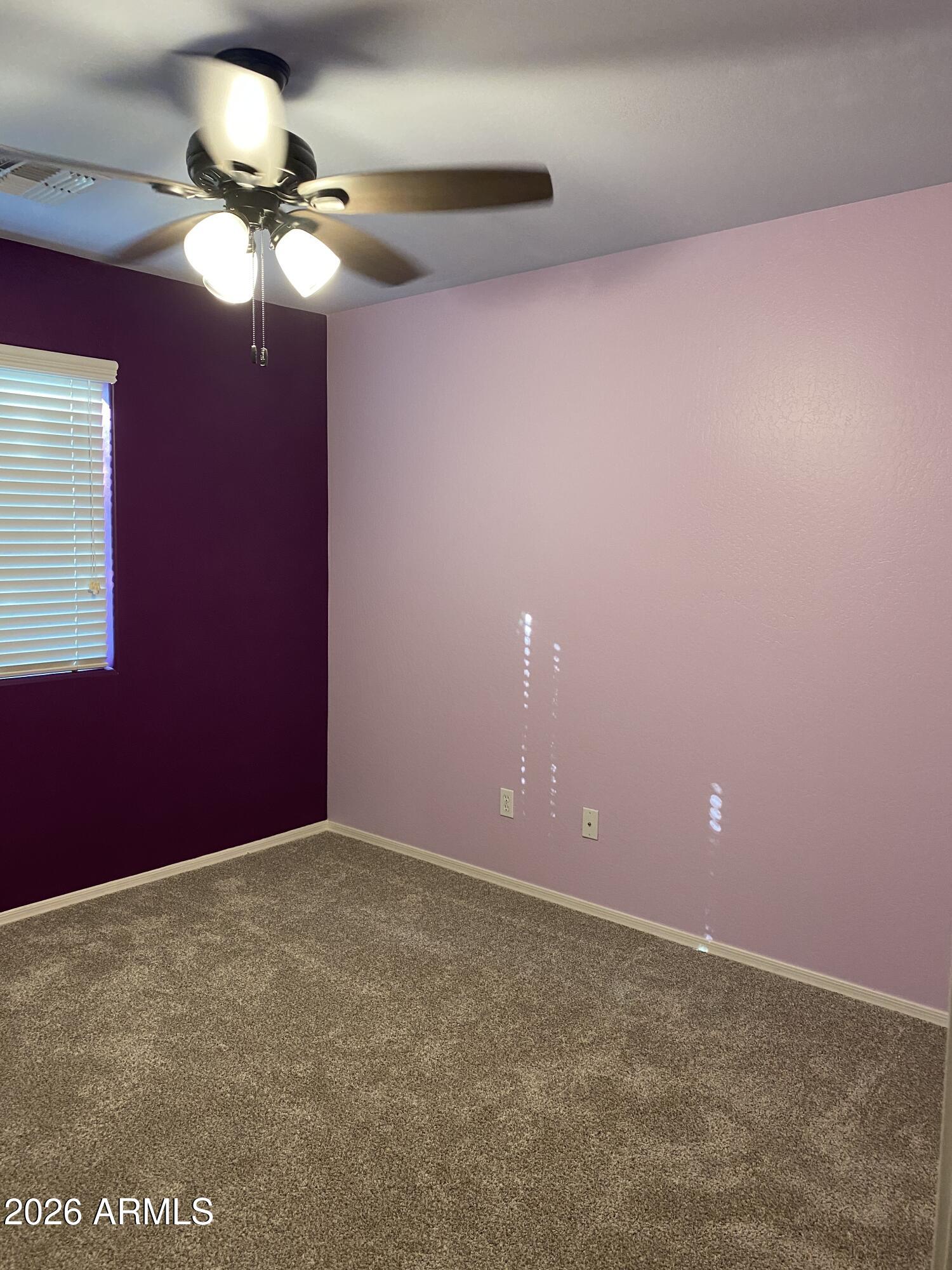 10225 West Camelback Road, Unit 19 Phoenix, AZ 85037 - Photo 29 of 51 a view of an empty room with a chandelier fan