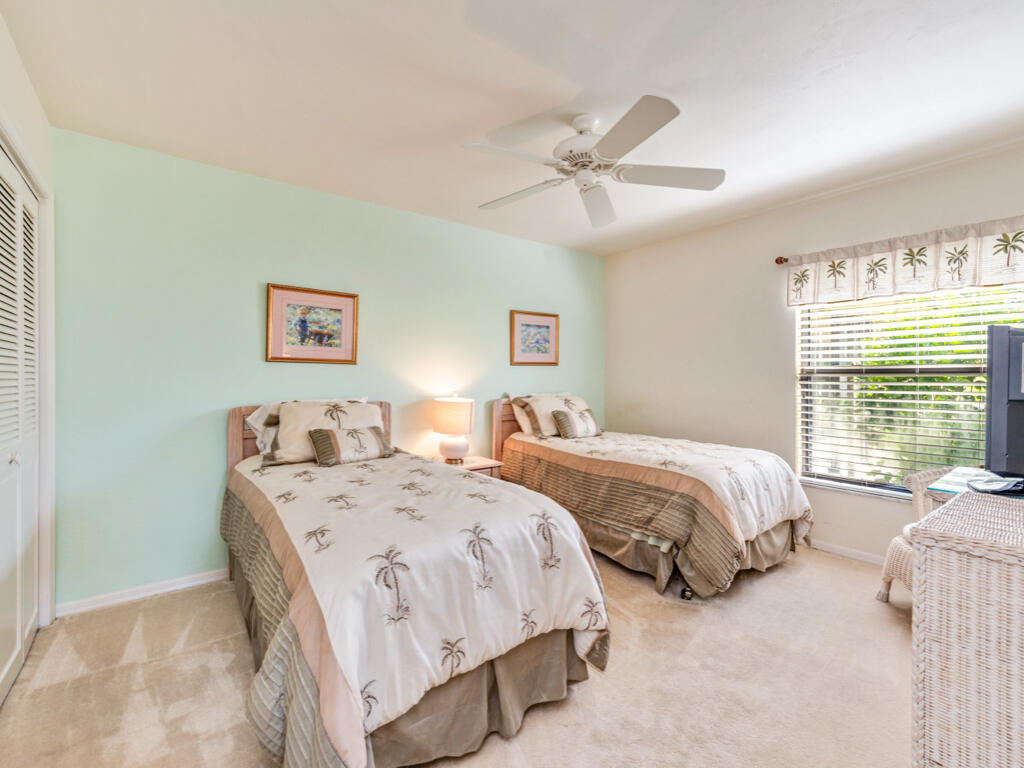 602 Augusta Boulevard, Unit 3 Naples, FL 34113 - Photo 7 of 8 a bedroom with two beds and a large window