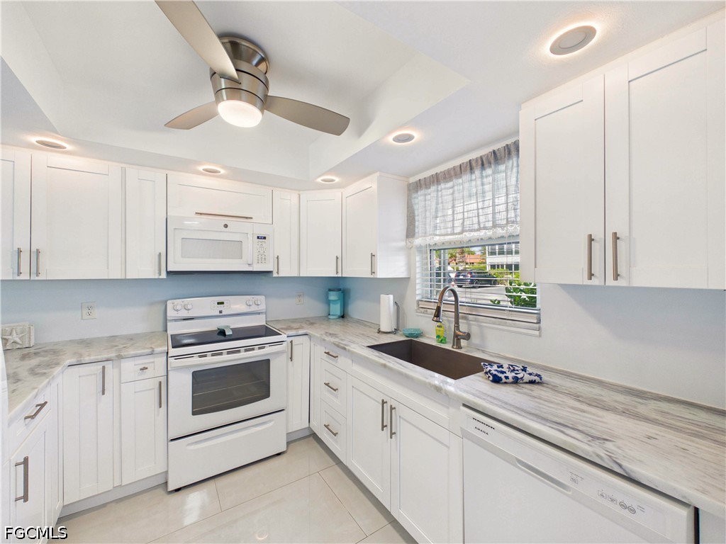 300 Valley Stream Drive, Unit 3D Naples, FL 34113 - Photo 9 of 21 a kitchen with white cabinets and white appliances