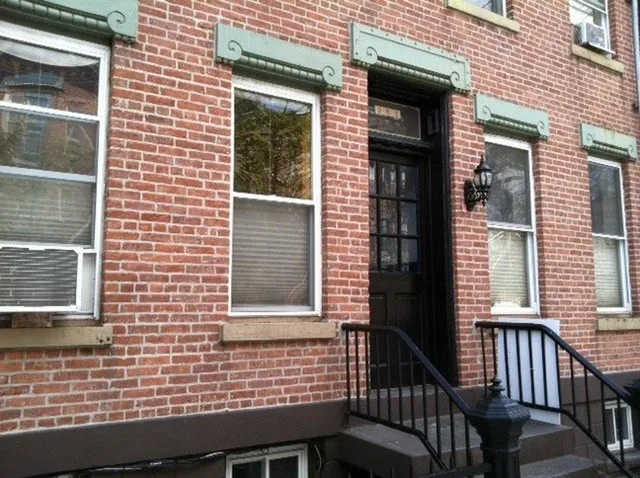 a view of a brick house with a large window