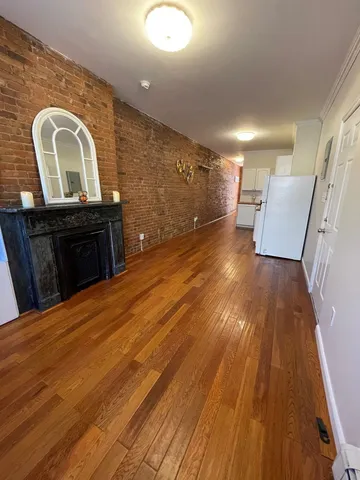 a view of a living room with wooden floor