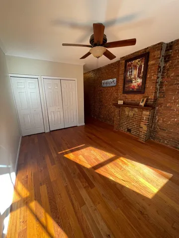 a view of a room with wooden floor