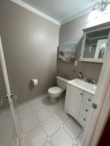 a bathroom with a sink a toilet and a mirror