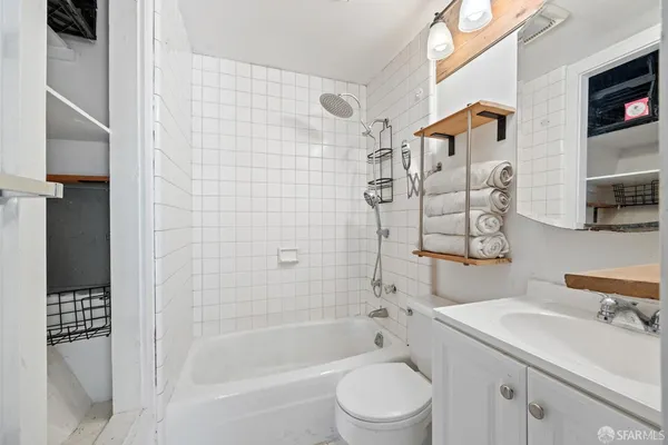 a bathroom with a shower toilet and sink