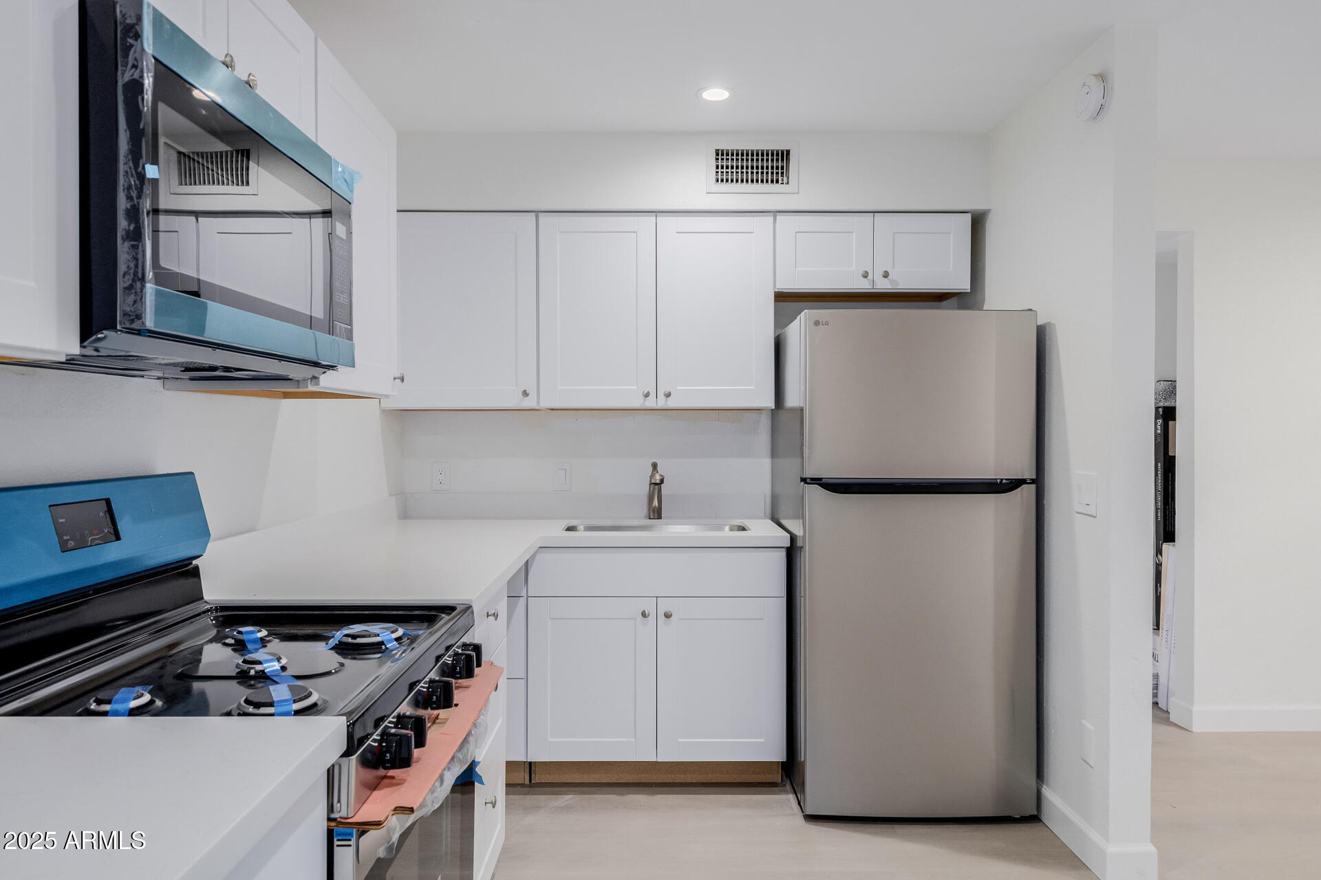 936 West Rio Salado Parkway, Unit 3 Mesa, AZ 85201 - Photo 11 of 26 a kitchen with a sink a stove and refrigerator