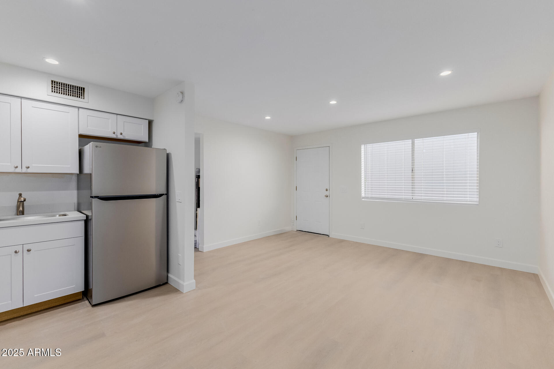 936 West Rio Salado Parkway, Unit 3 Mesa, AZ 85201 - Photo 13 of 26 a view of an empty room with a kitchen