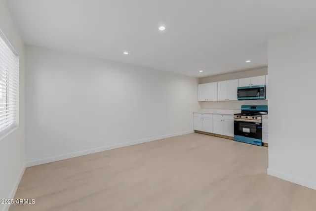 a view of kitchen with refrigerator and window