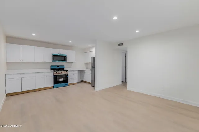 a view of kitchen with stainless steel appliances refrigerator and microwave