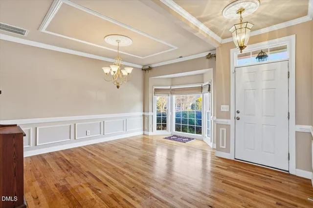 a bedroom with wooden floor and windows