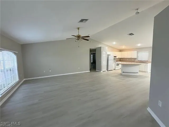 a view of a kitchen with a sink and a window