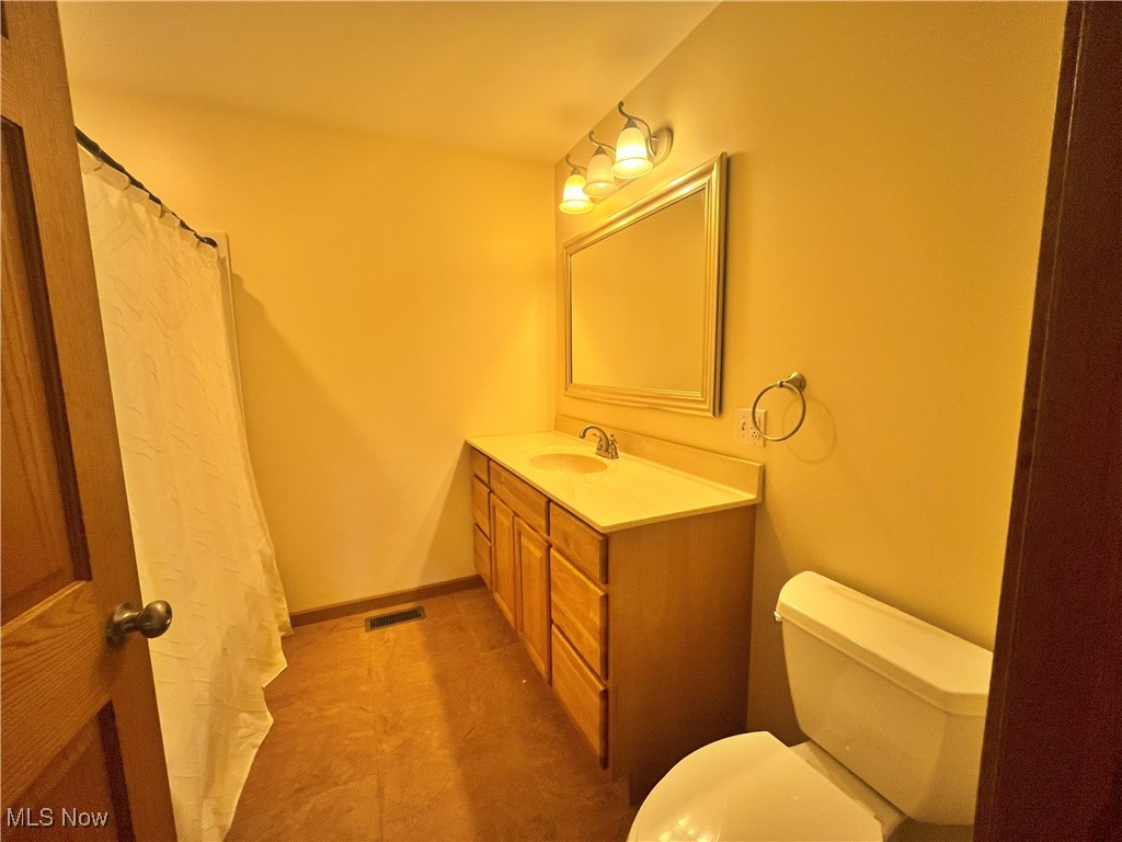 17583 Davis Ridge Road Caldwell, OH 43724 - Photo 28 of 42 Full bathroom with vanity and a shower with shower curtain