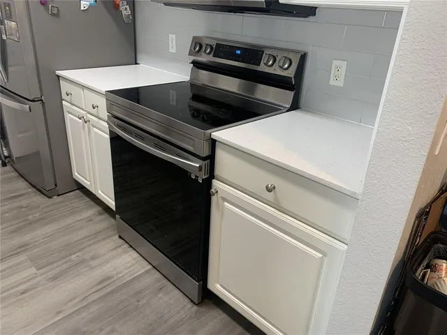 a stove top oven sitting inside of a kitchen