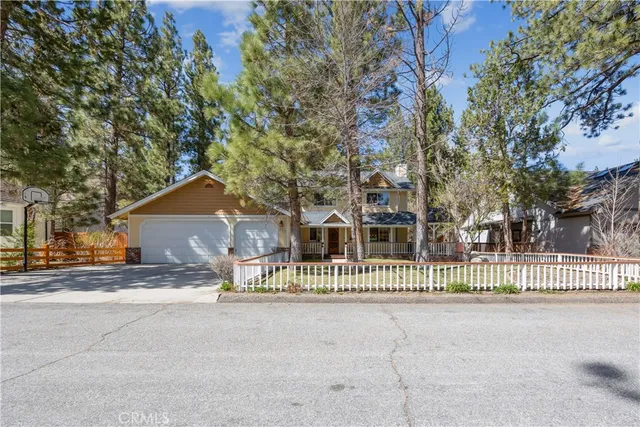 a view of a house with a fence and a road