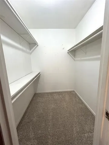 a spacious bathroom with a granite countertop toilet a sink and a bathtub
