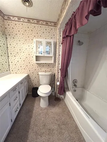 a view of a house with a yard and tree