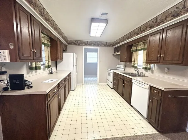 a kitchen with a sink stove and cabinets