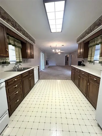 a large kitchen with a sink and cabinets