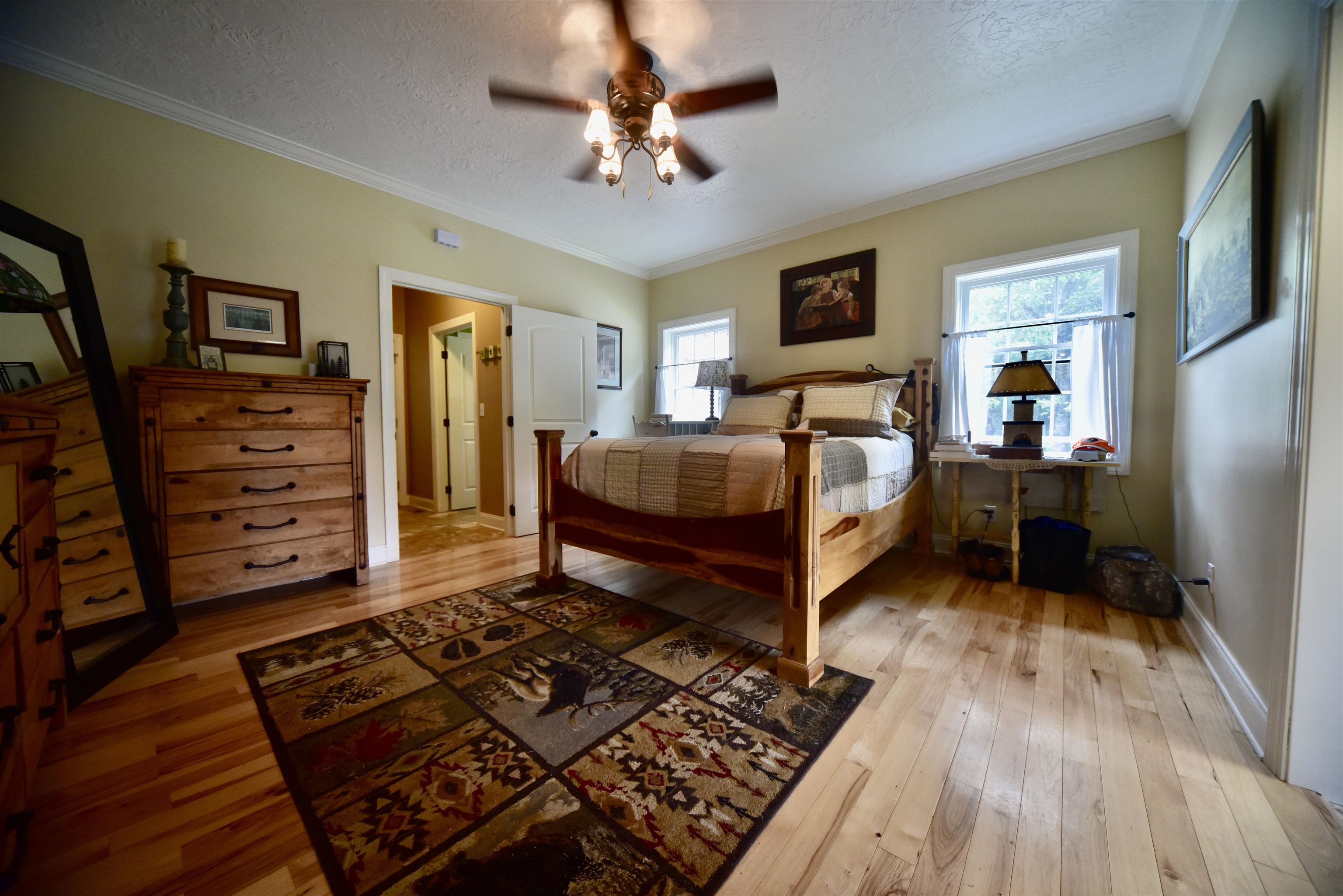 1359 Macks Grove Road Palmersville, TN 38241 - Photo 13 of 40 Bedroom featuring wood-type flooring, a textured ceiling, crown molding, baseboards, and a ceiling fan
