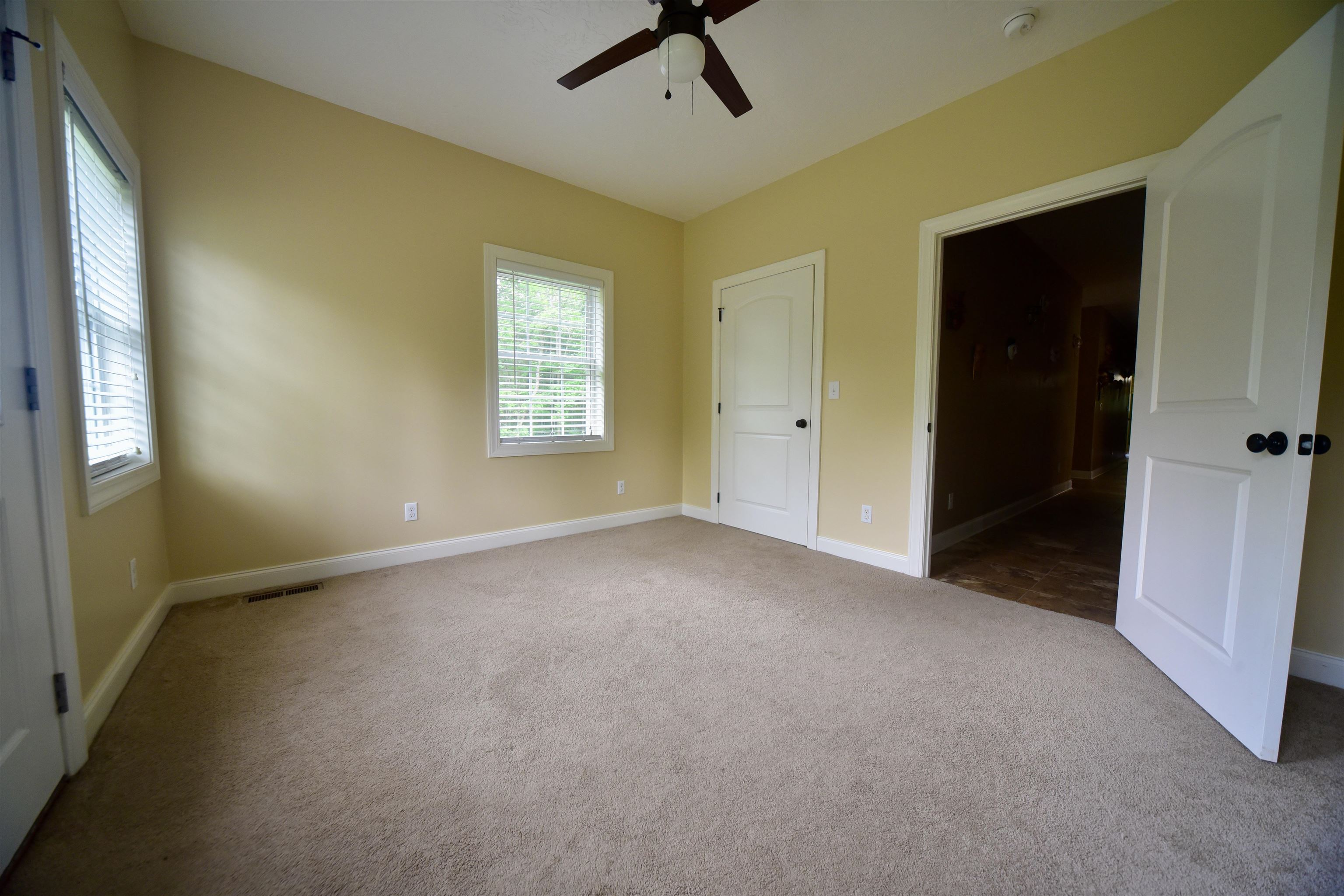 1359 Macks Grove Road Palmersville, TN 38241 - Photo 18 of 40 Unfurnished bedroom featuring carpet floors, multiple windows, baseboards, and ceiling fan