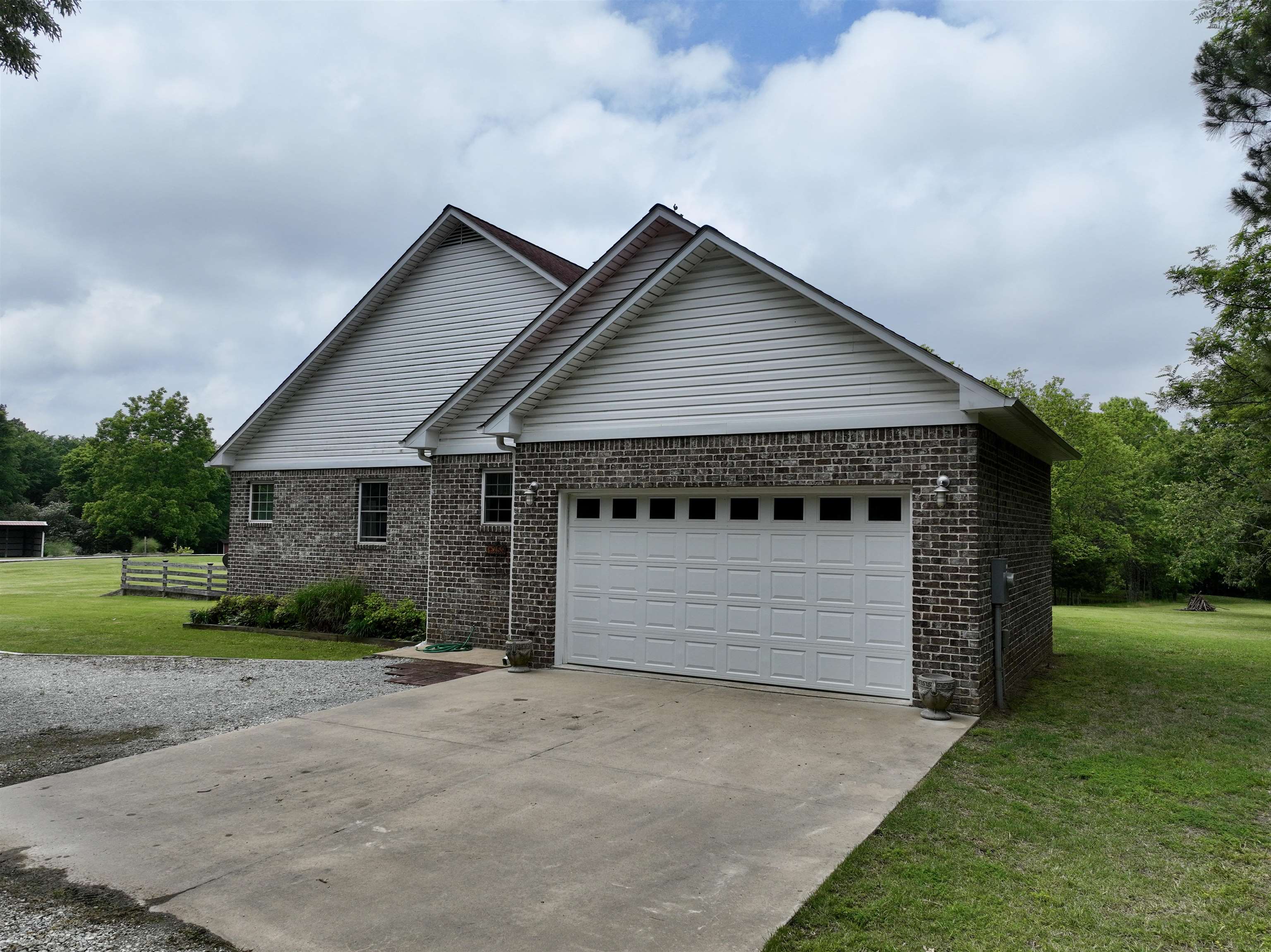 1359 Macks Grove Road Palmersville, TN 38241 - Photo 2 of 40 View of front of property with a front yard, brick siding, an attached garage, and driveway