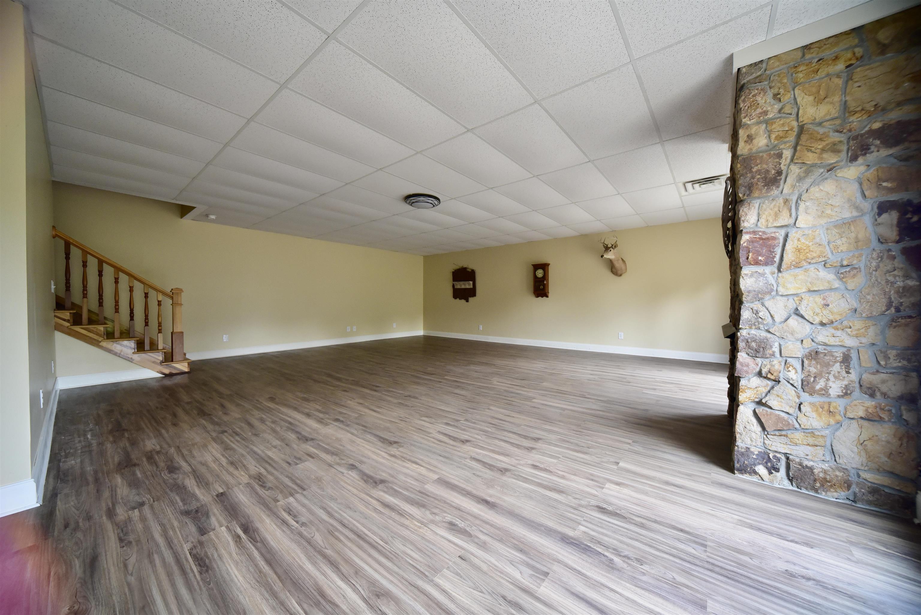 1359 Macks Grove Road Palmersville, TN 38241 - Photo 21 of 40 Unfurnished living room with stairway, a paneled ceiling, baseboards, and wood finished floors