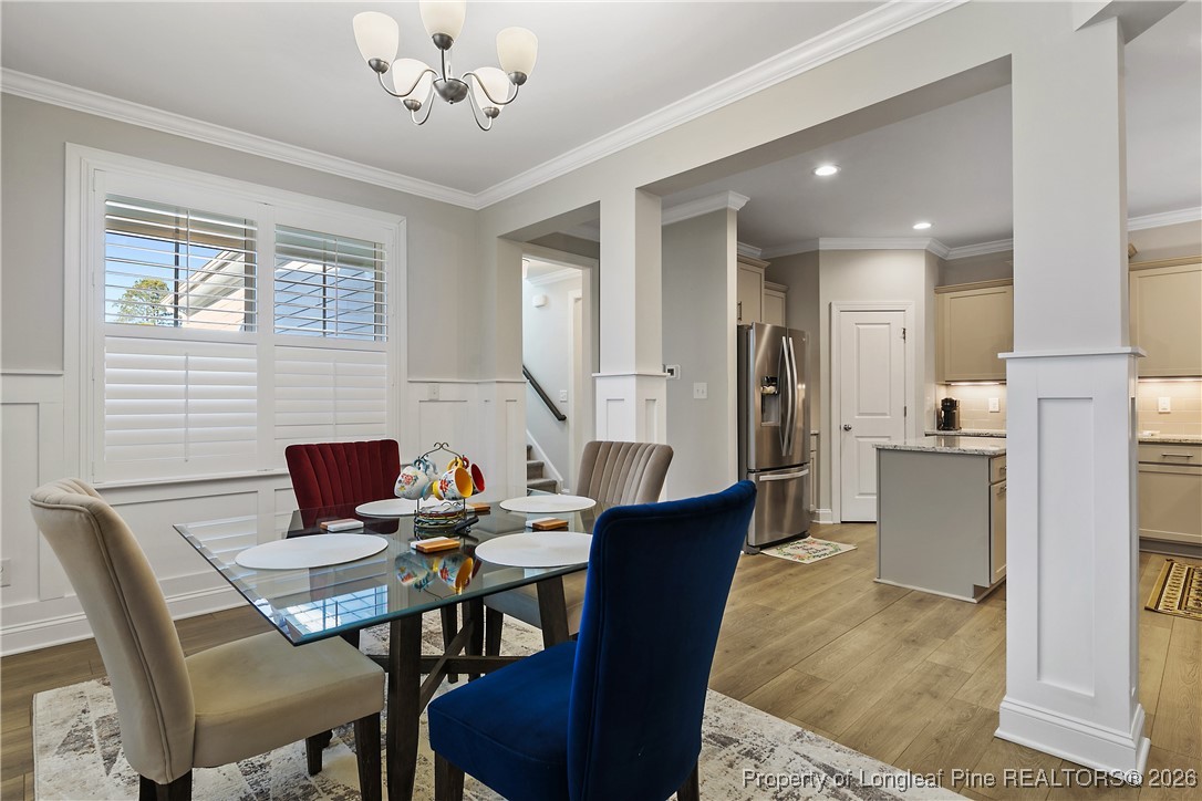 88 Spruce Hollow Circle Spring Lake, NC 28390 - Photo 11 of 48 a view of a dining room with furniture and chandelier