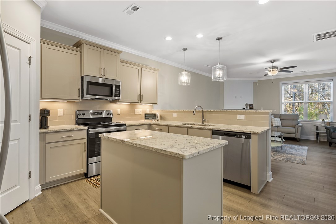 88 Spruce Hollow Circle Spring Lake, NC 28390 - Photo 13 of 48 a kitchen with stainless steel appliances granite countertop a sink stove and refrigerator