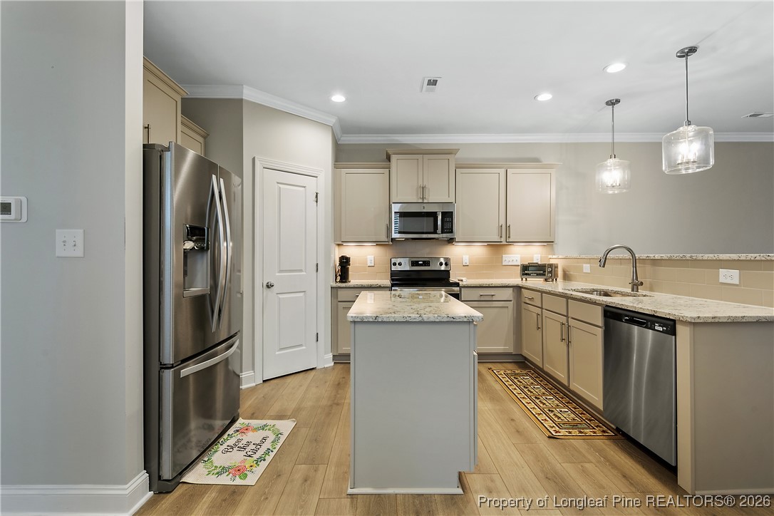 88 Spruce Hollow Circle Spring Lake, NC 28390 - Photo 14 of 48 a kitchen with stainless steel appliances granite countertop a refrigerator a sink a stove and white cabinets