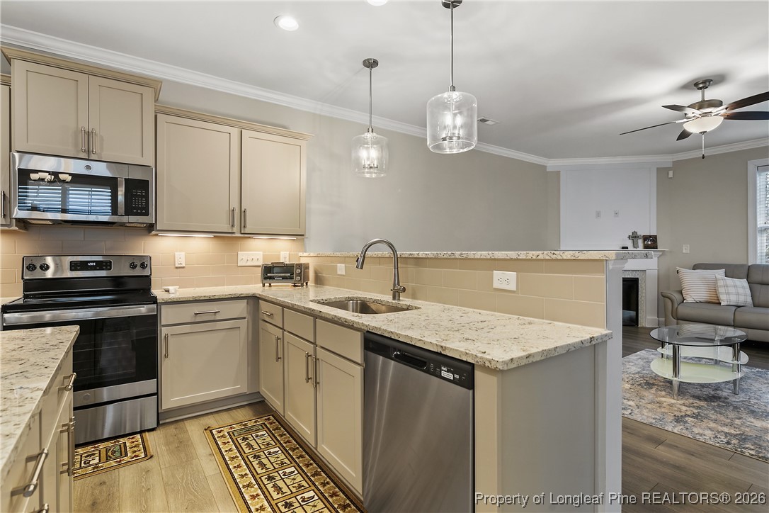 88 Spruce Hollow Circle Spring Lake, NC 28390 - Photo 15 of 48 a kitchen with a sink stainless steel appliances and cabinets
