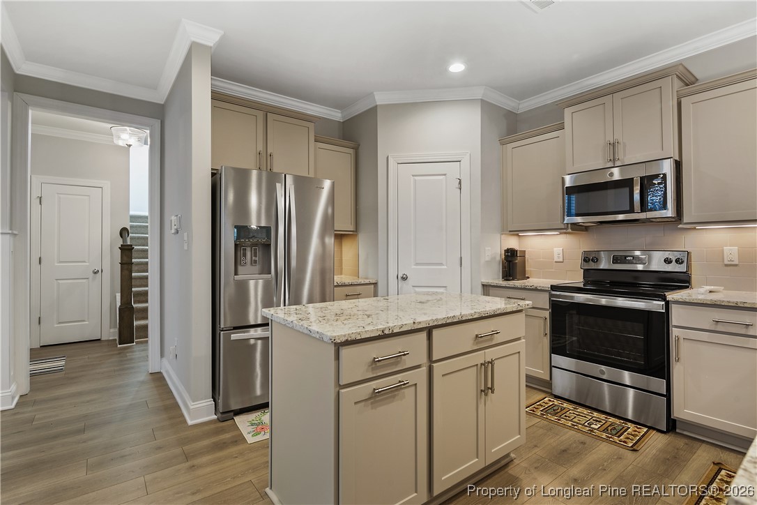 88 Spruce Hollow Circle Spring Lake, NC 28390 - Photo 16 of 48 a kitchen with stainless steel appliances granite countertop a refrigerator stove and sink