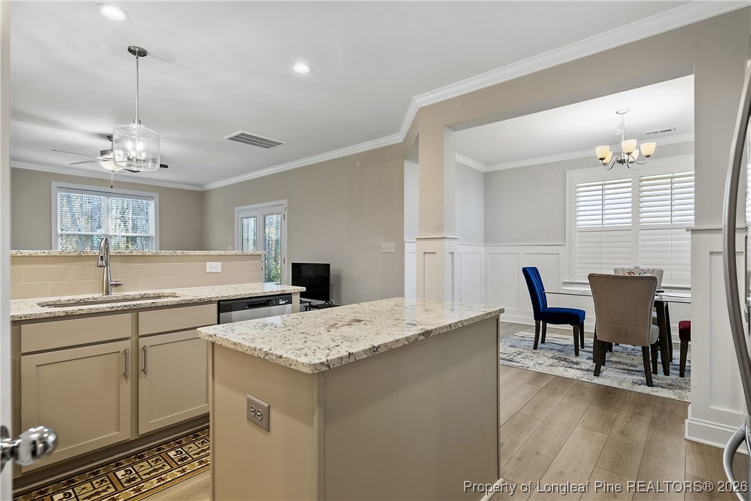 88 Spruce Hollow Circle Spring Lake, NC 28390 - Photo 18 of 48 a kitchen with a stove a sink a dining table and chairs