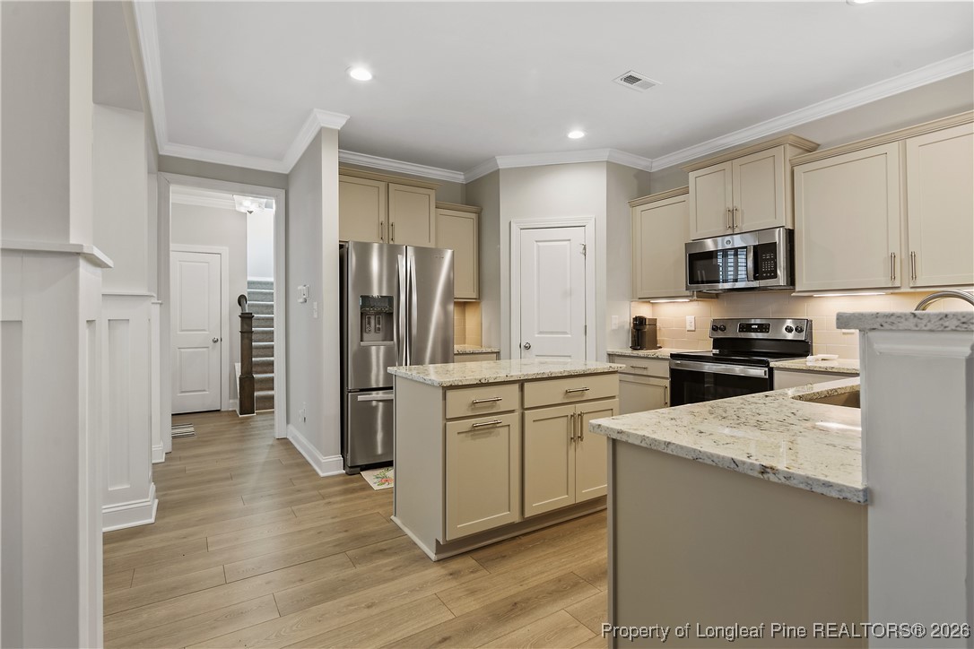 88 Spruce Hollow Circle Spring Lake, NC 28390 - Photo 19 of 48 a kitchen with stainless steel appliances granite countertop a refrigerator a stove top oven a sink and dishwasher
