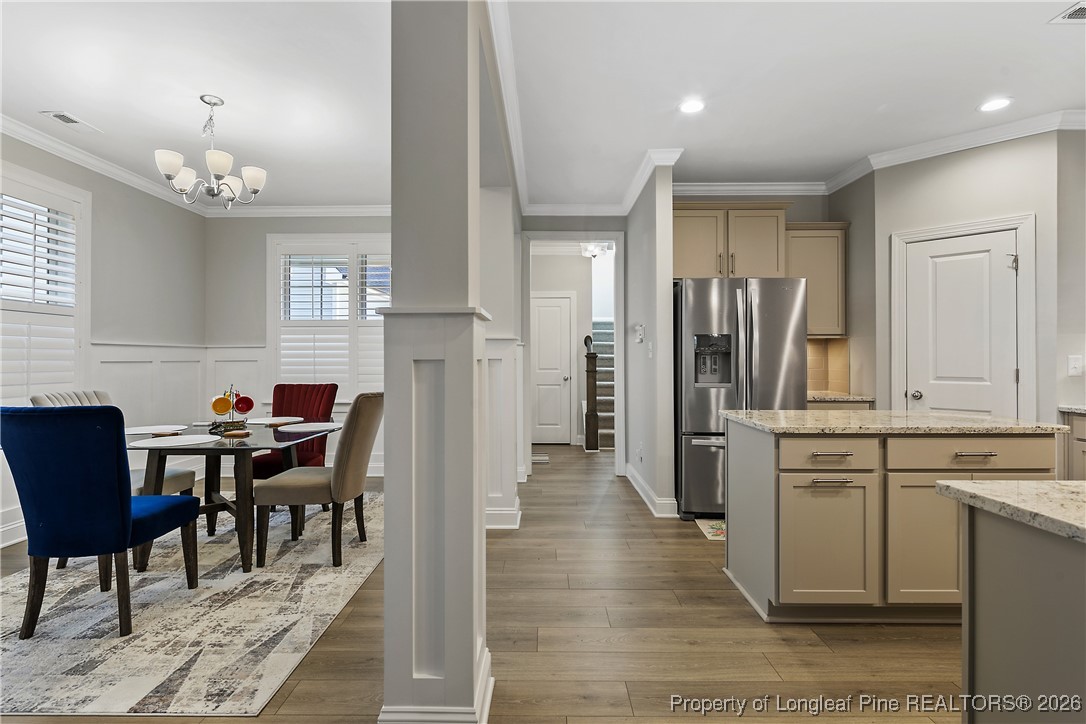 88 Spruce Hollow Circle Spring Lake, NC 28390 - Photo 20 of 48 a kitchen with stainless steel appliances kitchen island granite countertop a refrigerator and cabinets