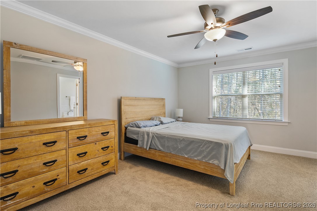88 Spruce Hollow Circle Spring Lake, NC 28390 - Photo 25 of 48 a bedroom with a bed dresser and a window