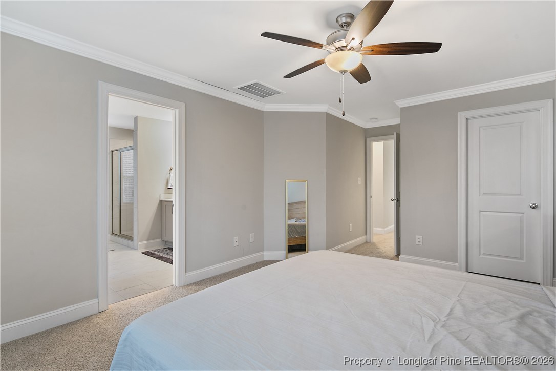 88 Spruce Hollow Circle Spring Lake, NC 28390 - Photo 27 of 48 a bedroom with a bed and a ceiling fan
